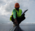 Professional performing a roof inspection on a home