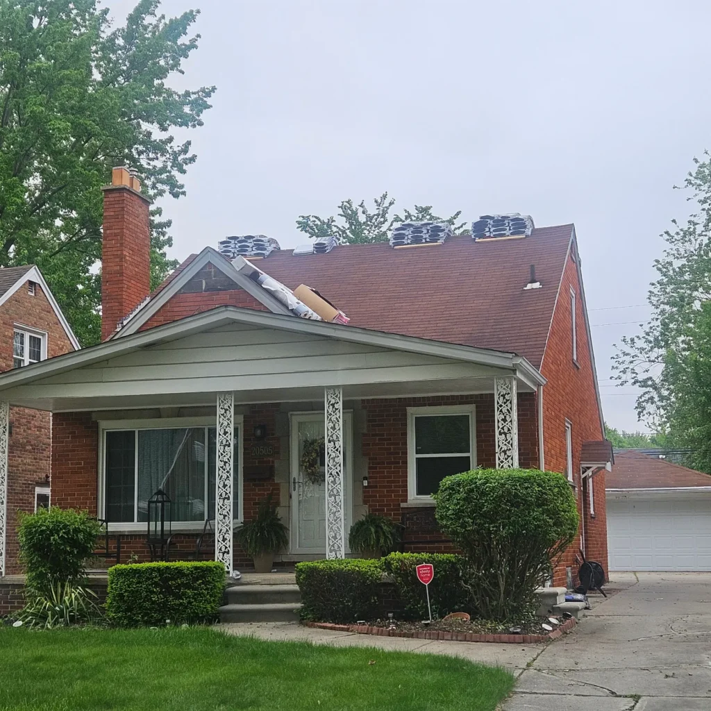 Brick home with a new dark roof and skyl