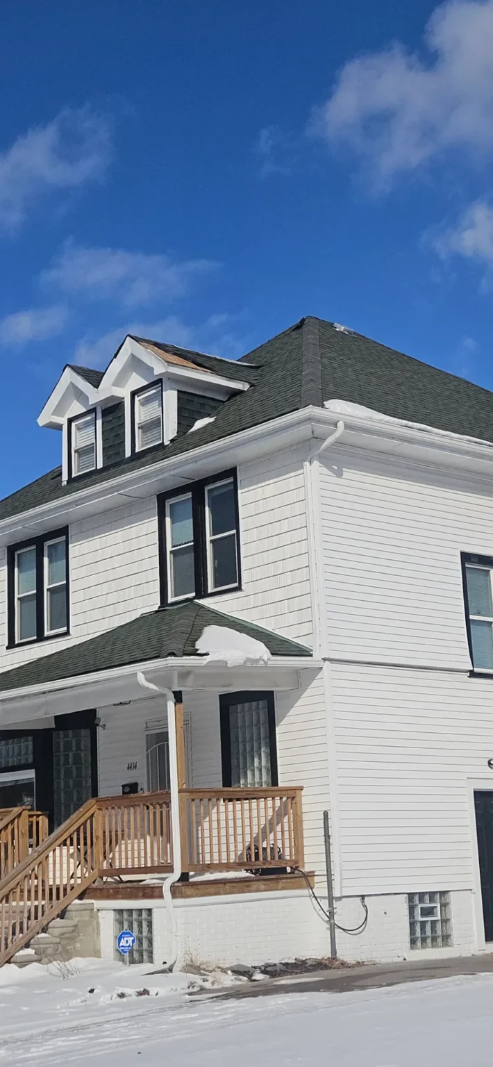Colonial home with dormers and new shingles installed by T&M Roofing