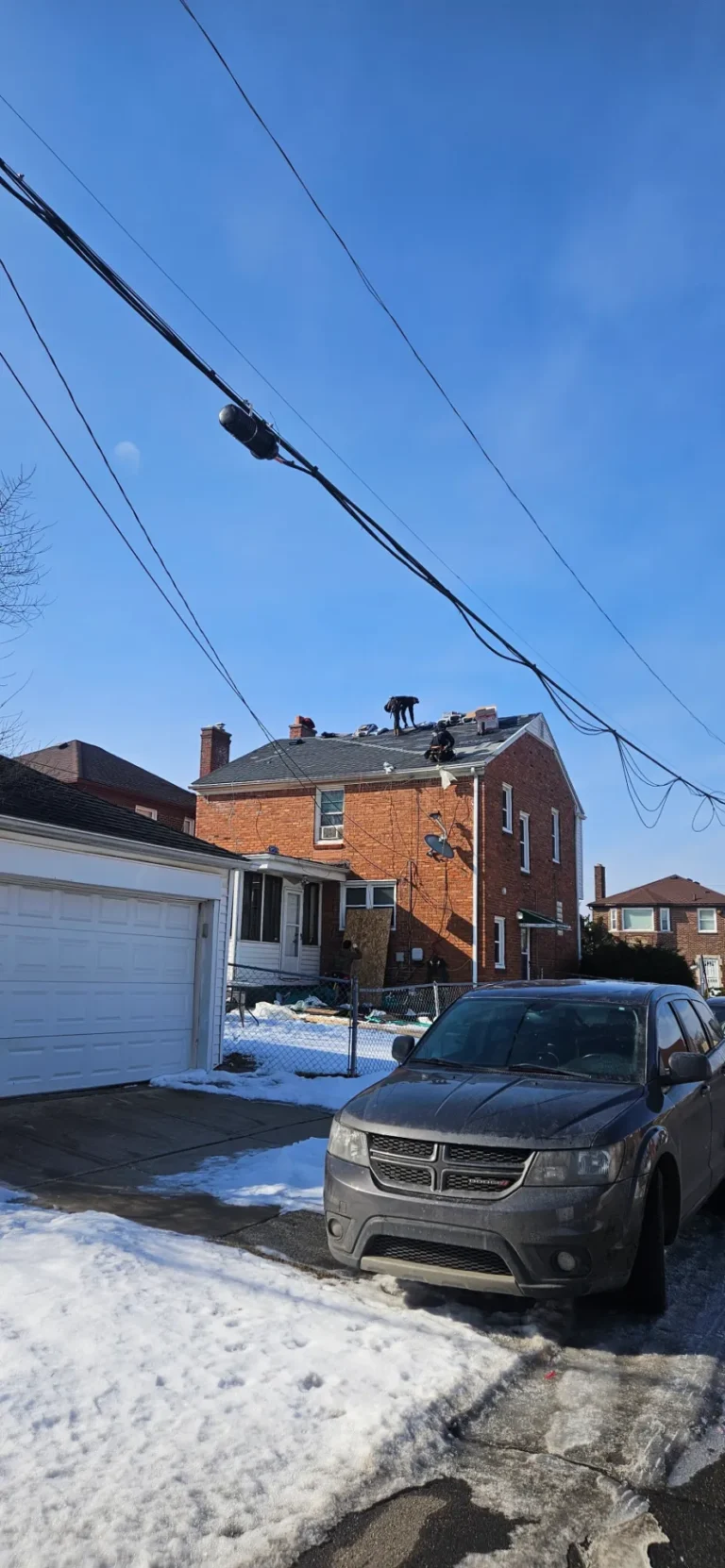 Crew on a brick home with attached garage