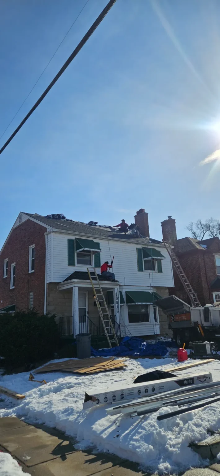 Crew tearing off a colonial roof – T&M Roofing project in Metro Detroit