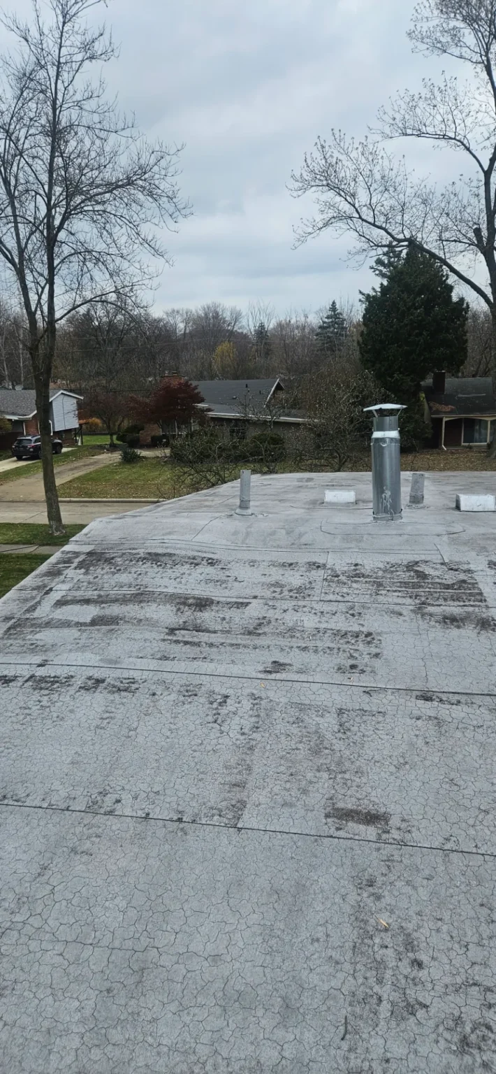 Coated flat roof repaired by T&M Roofing to stop a leak