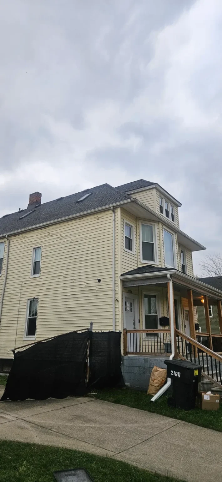 Home with new shingles and a dormer, roof replaced by T&M Roofing